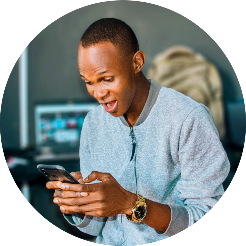 a man wearing a watch is looking at his phone