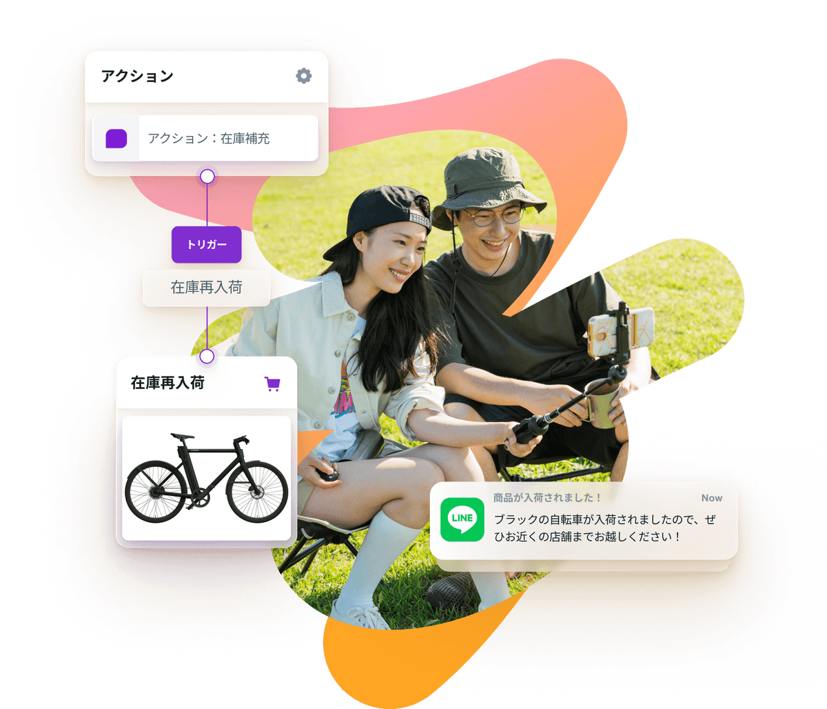 a man and a woman are sitting in the grass with a bicycle in the background