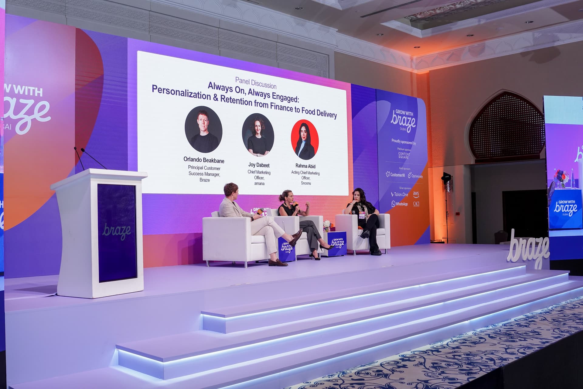 Three panelists discuss personalization and retention on a purple Braze-branded stage.